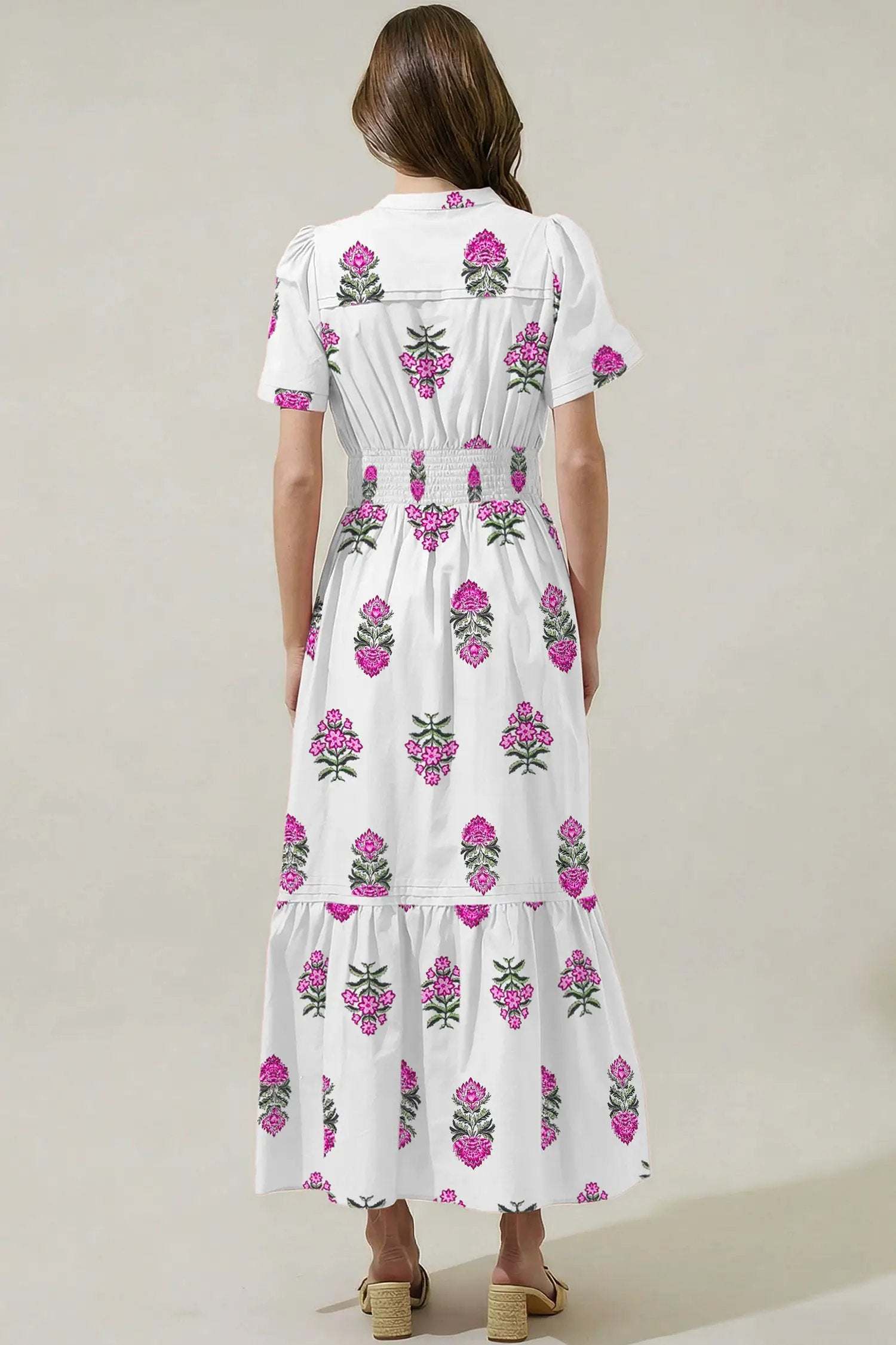 Woman in floral print split neck maxi dress with shirred waist and ruffle hem conveying main character energy