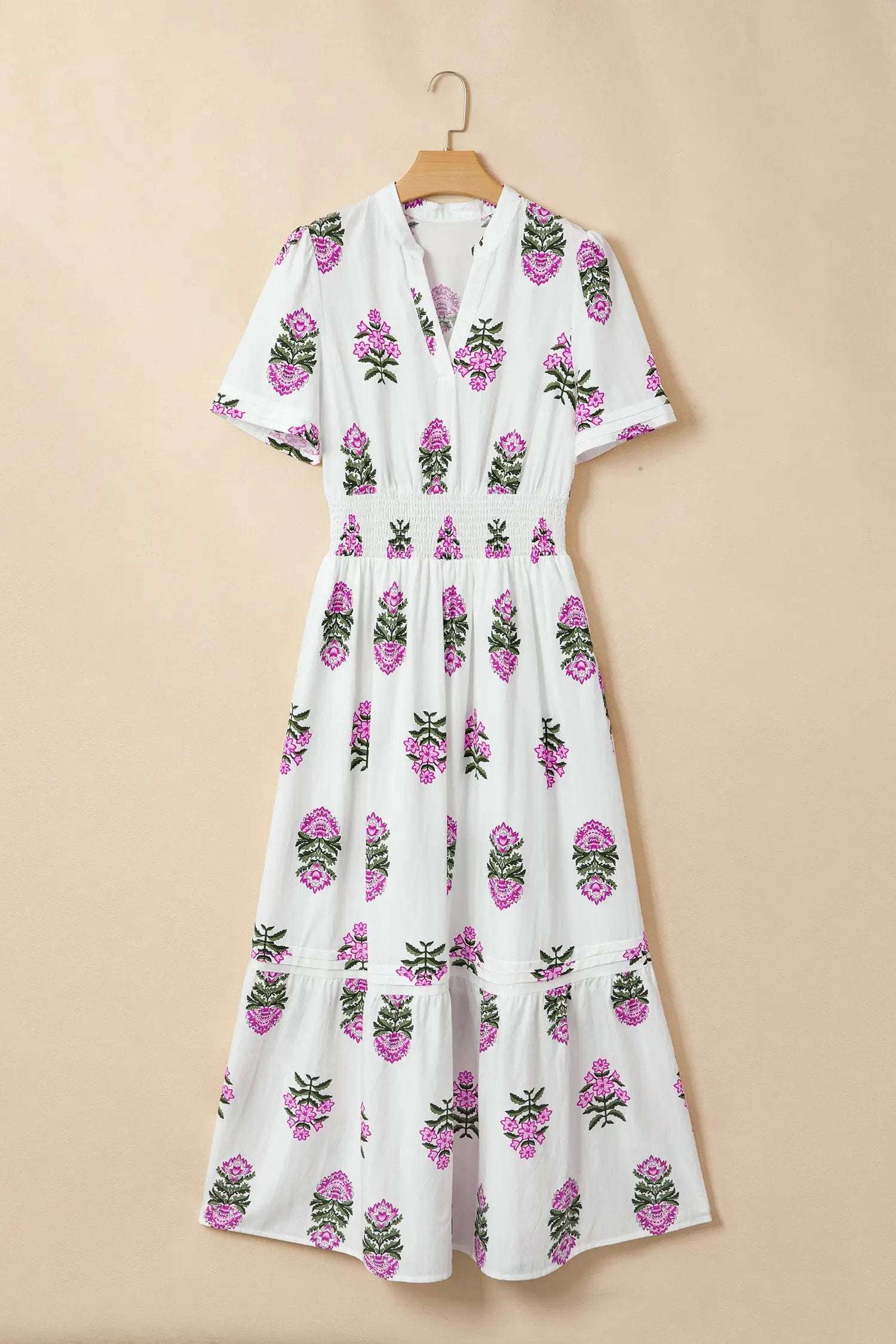 Woman wearing a floral print split neck maxi dress with shirred waist and ruffle hem embodying main character energy