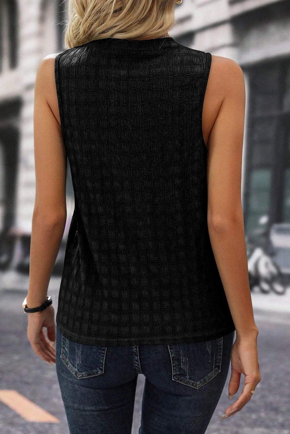White lattice textured split-neck tank top on a mannequin showcasing relaxed fit and breathable fabric