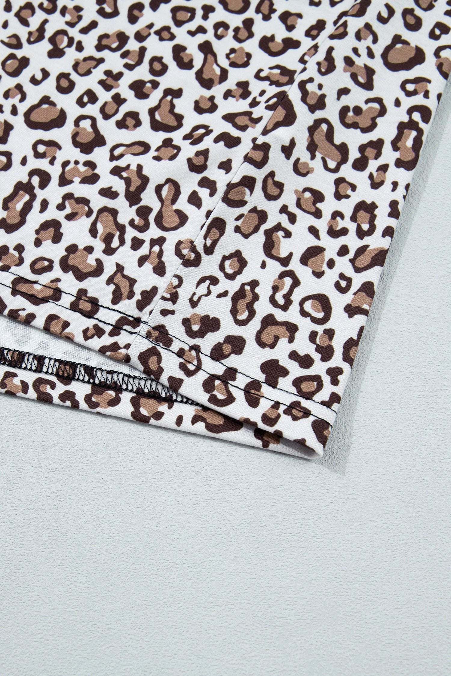 Plus size leopard top with khaki contrast trim sleeveless for casual and versatile wear