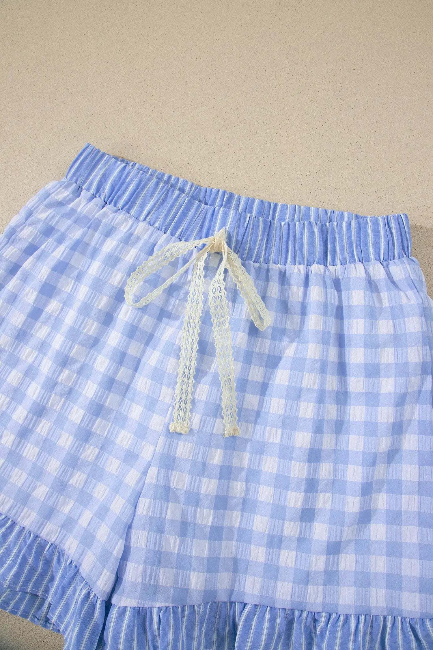 Gingham ruffle hem shorts with lace tie waist in lightweight breathable fabric