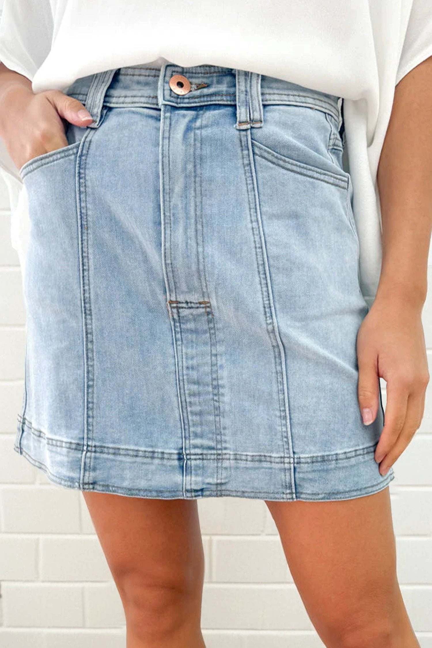 A-line denim mini skirt with exposed seam and pockets, stylish casual wear