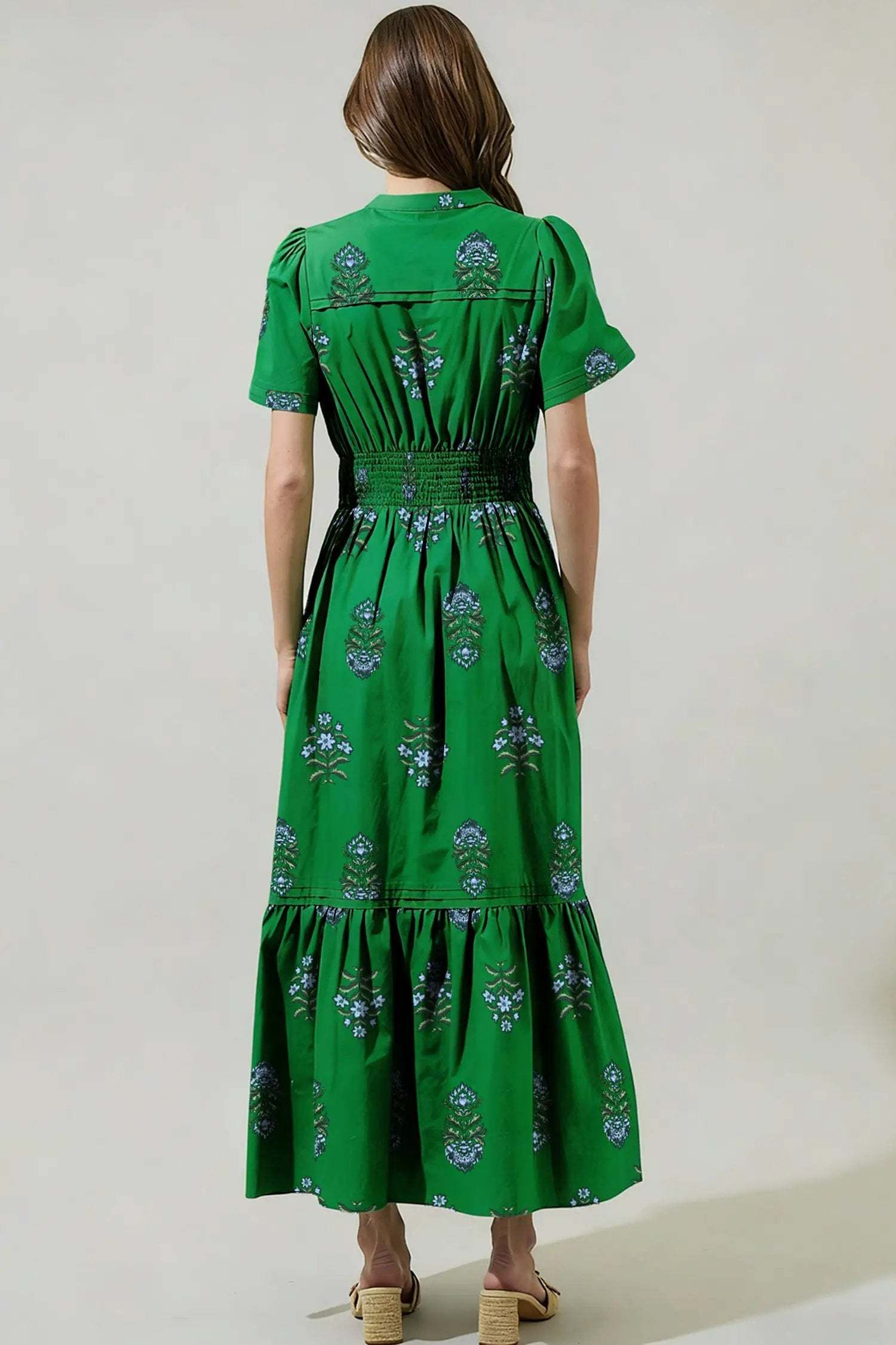 Woman wearing floral print split neck maxi dress with shirred waist and ruffle hem embodying main character energy