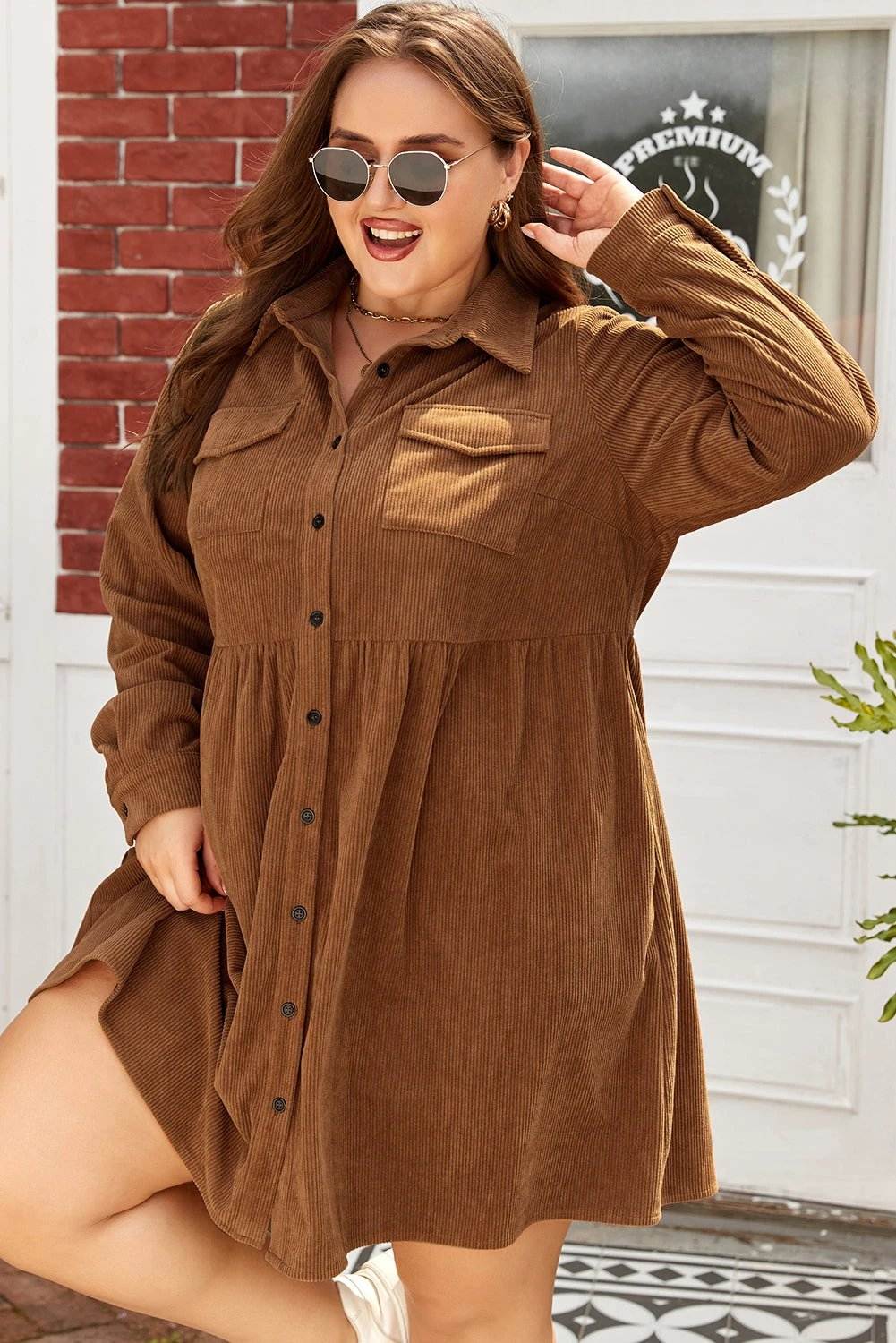 Plus size brown corduroy button-front shirt dress with collared neckline and A-line silhouette