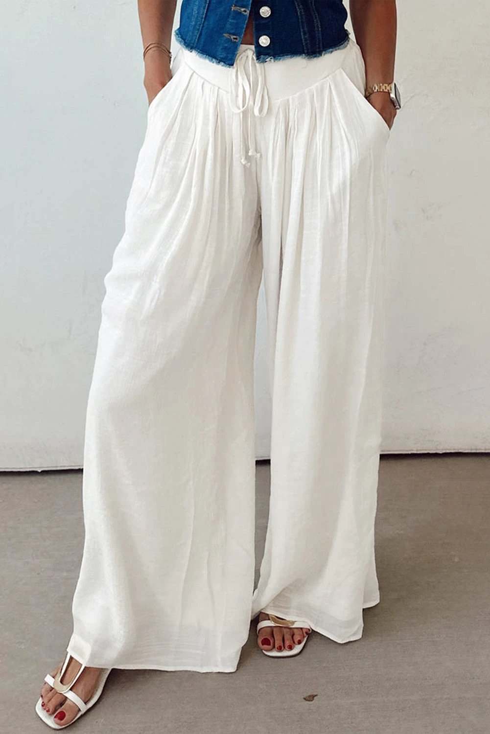 White drop-waist pleated wide-leg cotton-linen pants with drawstring waistband and side pockets