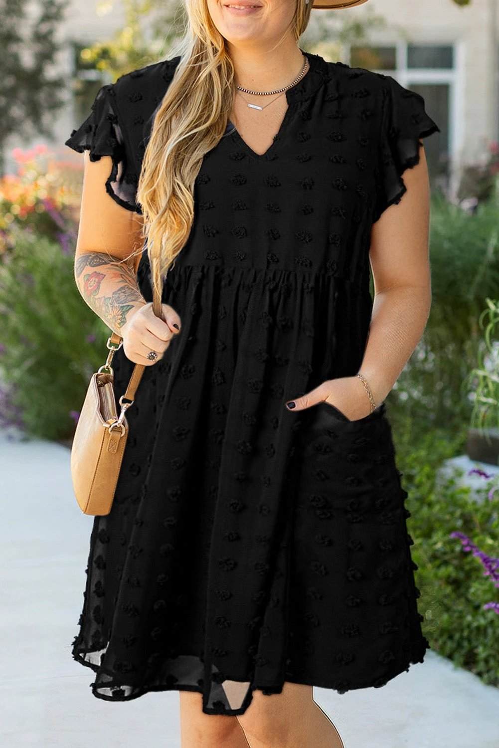 Plus-size black dotty textured dress with notched neck and ruffled sleeves