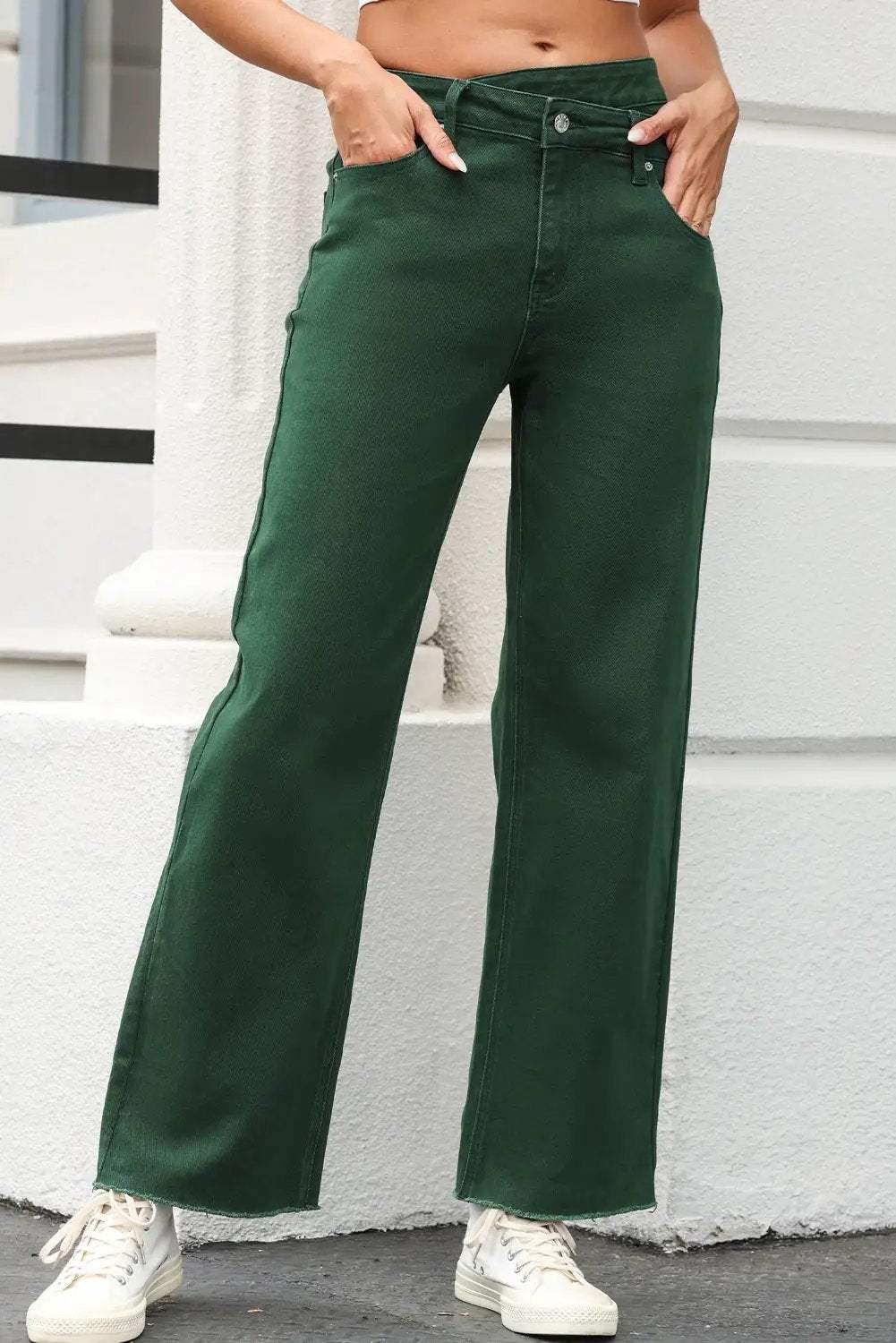 Woman wearing crossed waist raw-hem jeans with a relaxed straight-leg fit and casual western style