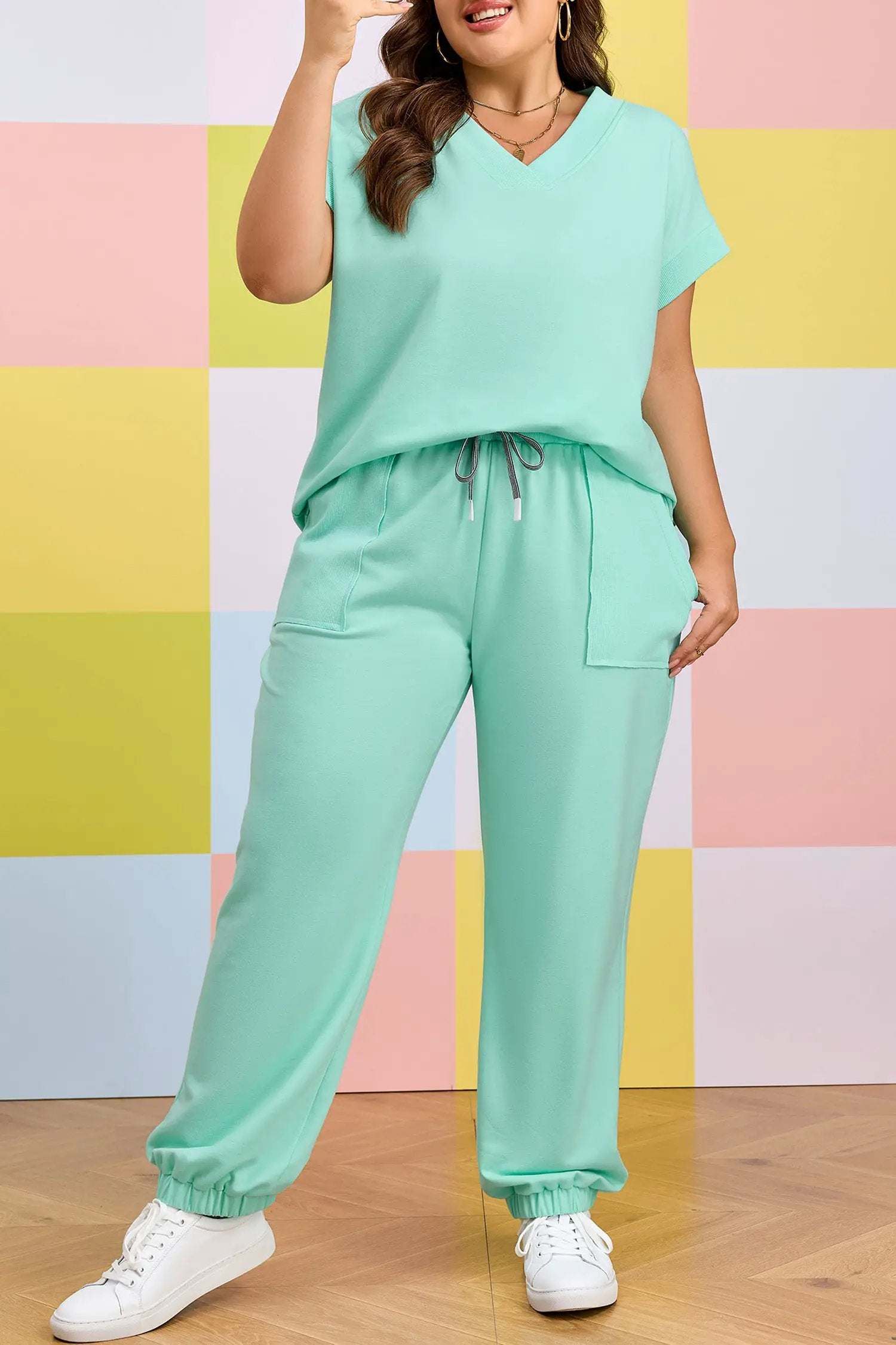 Plus size woman wearing Mom Vibes V-neck tee and drawstring pants outfit set