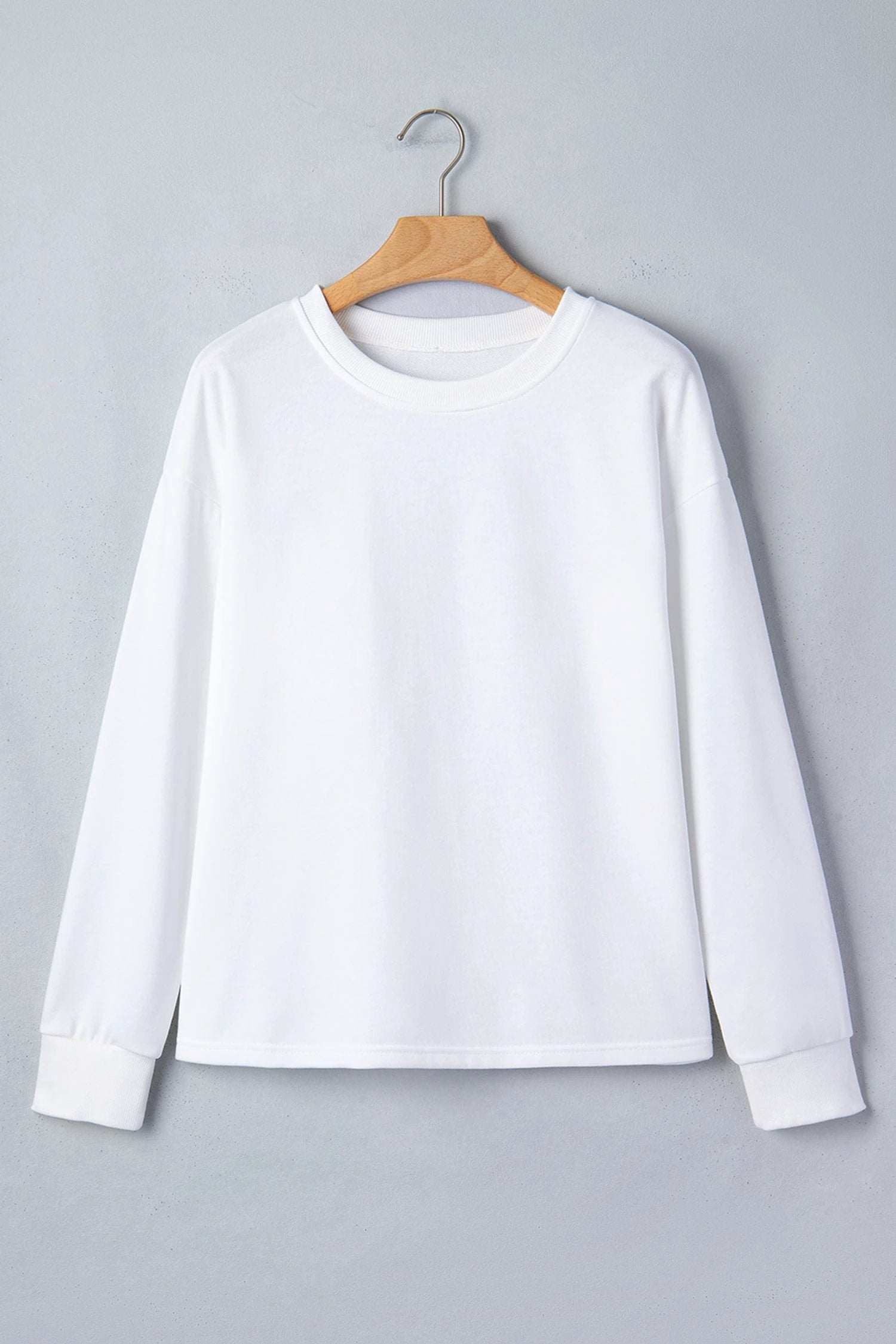 white solid color dropped shoulder long sleeve top for women casual everyday outfit