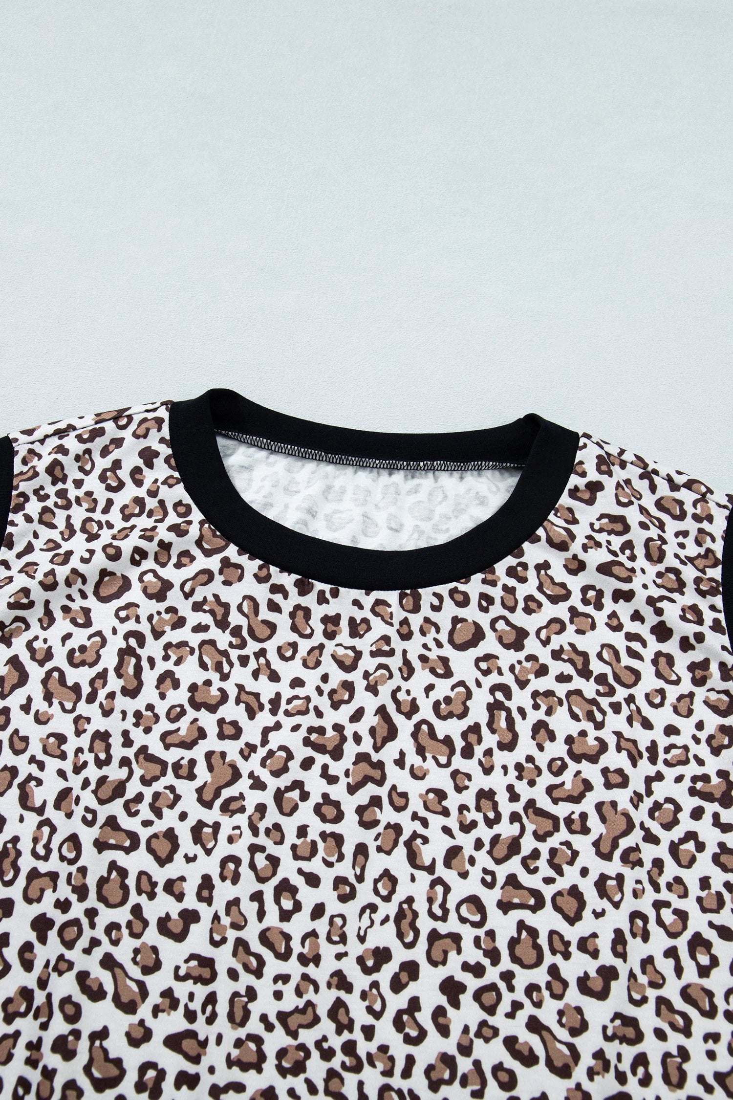 Plus size leopard top with khaki contrast trim and sleeveless design for comfortable everyday wear