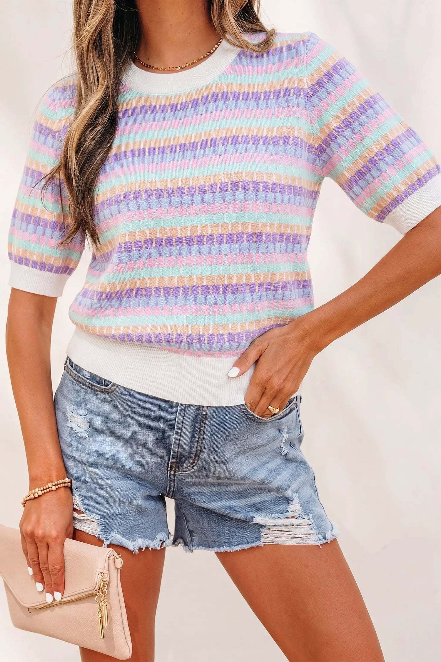 Orange striped knit sweater with short sleeves and abstract orange stripes