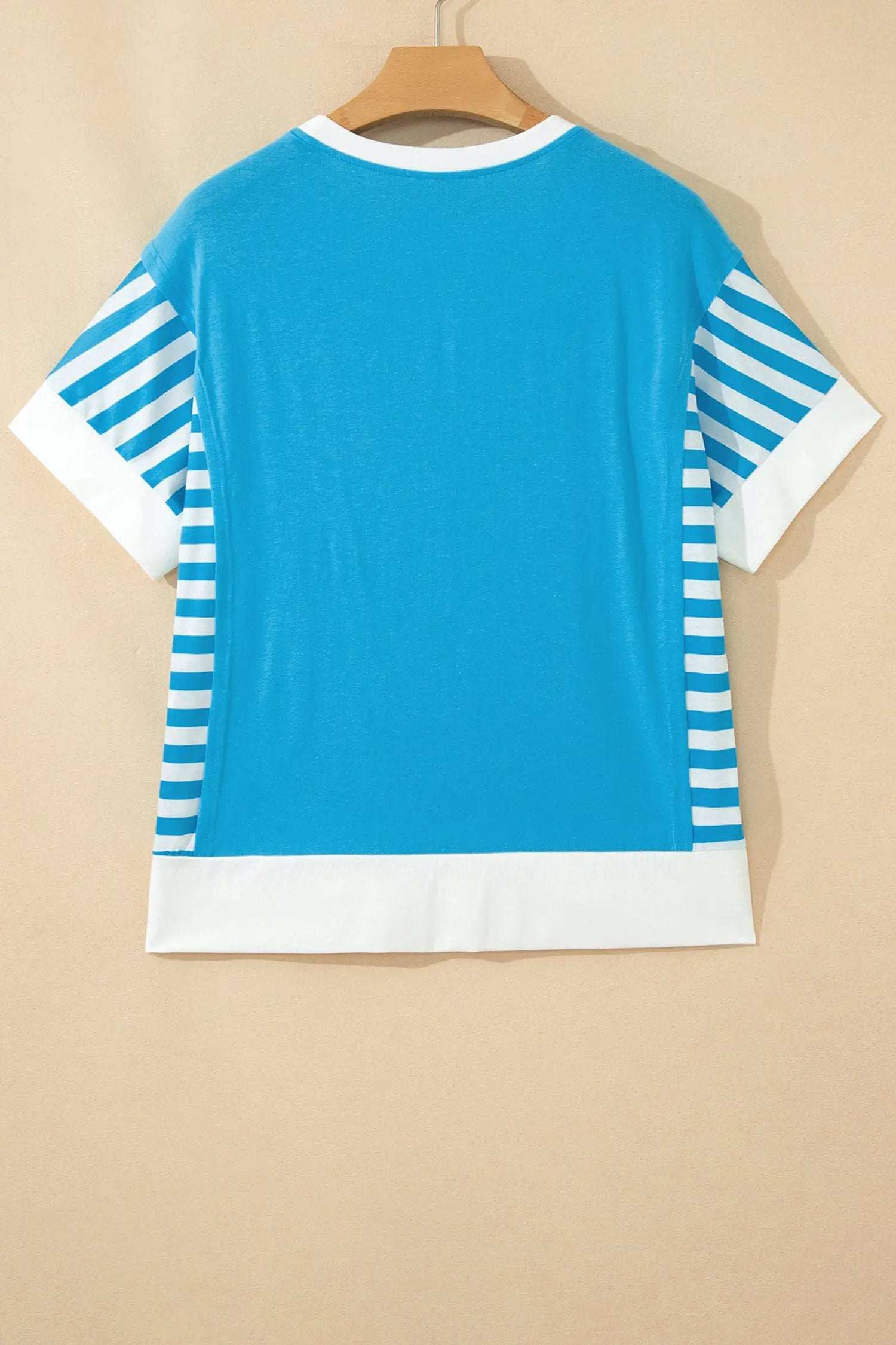 Woman wearing a soft cotton-blend patchwork US flag t-shirt with colorblock sleeves and starry chest panel.