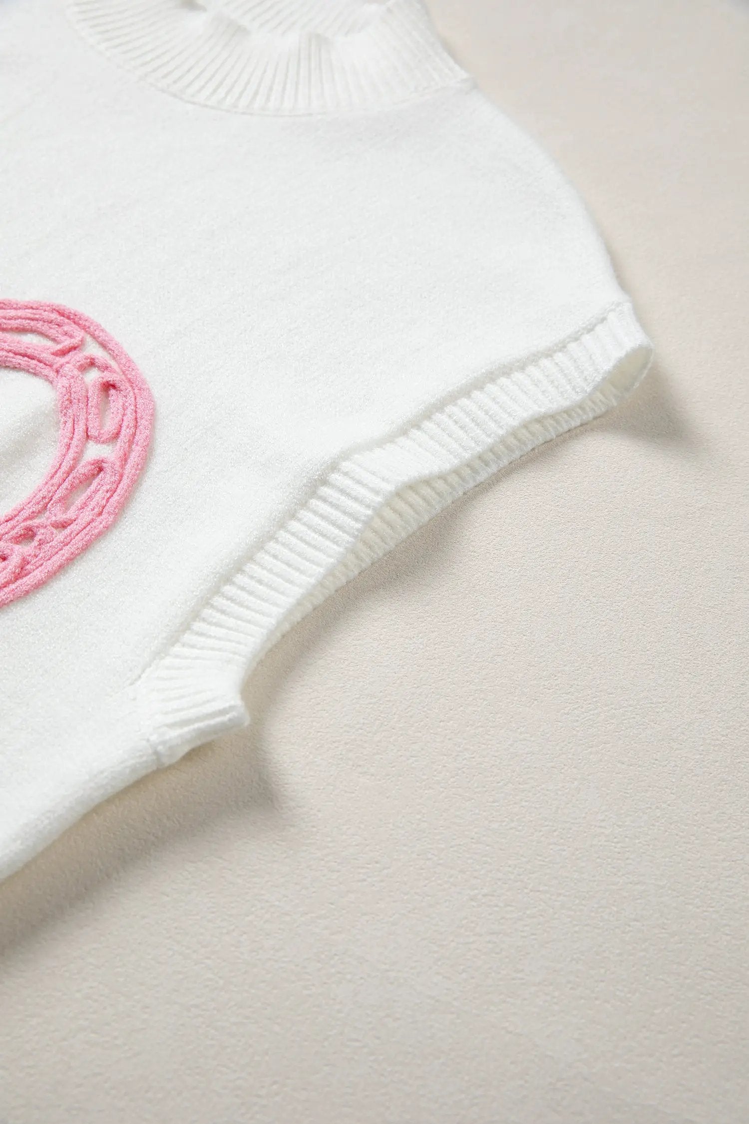 Bright green ribbed mock neck short sleeve sweater with pink horseshoe embroidery