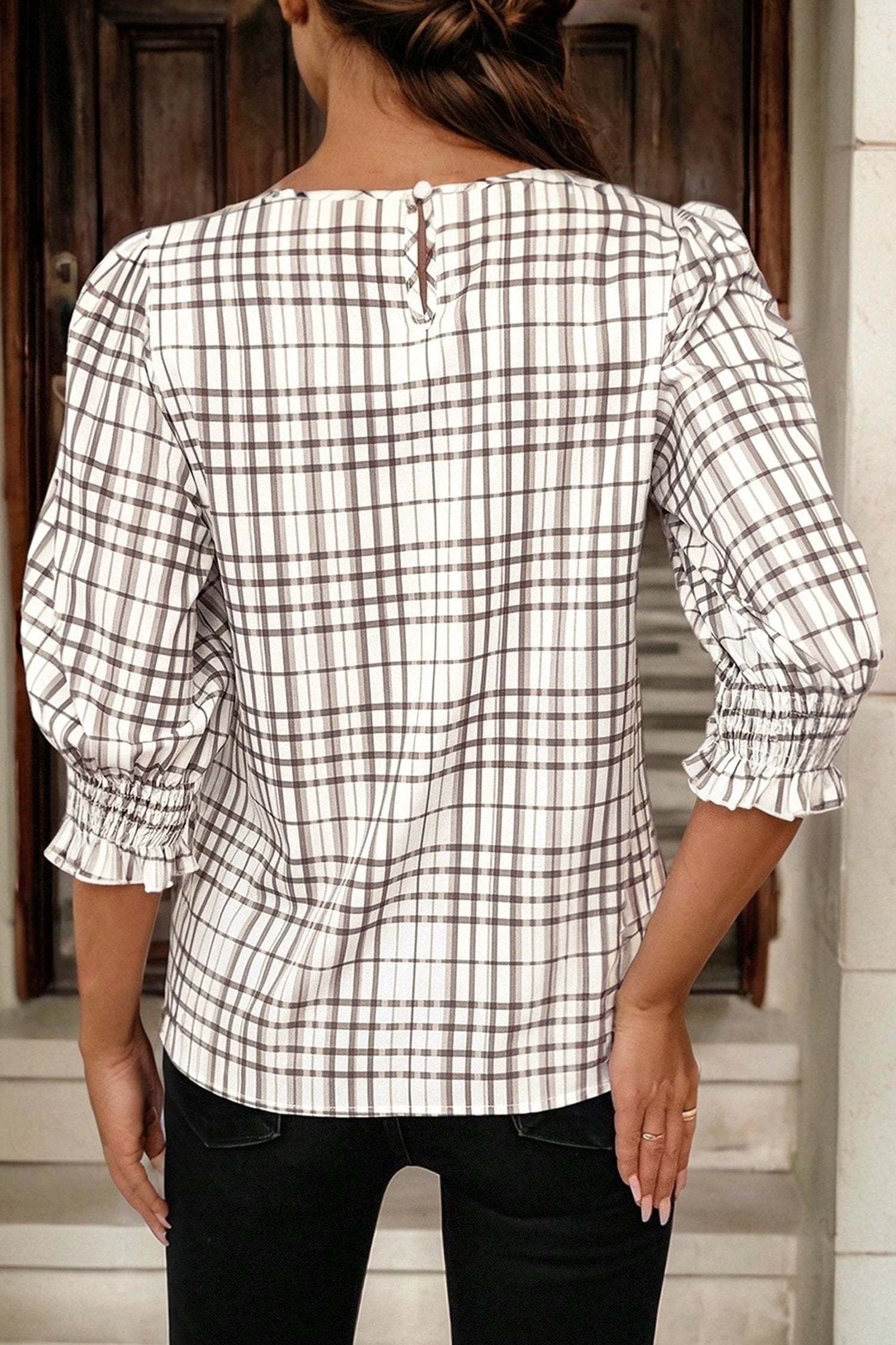 Woman wearing plaid frilled puff sleeve blouse showcasing effortless mom chic style