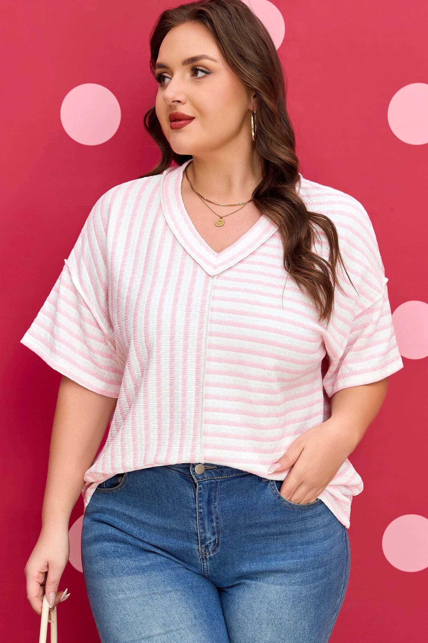 Plus size pink stripe V-neck tee with exposed seam detailing and relaxed fit