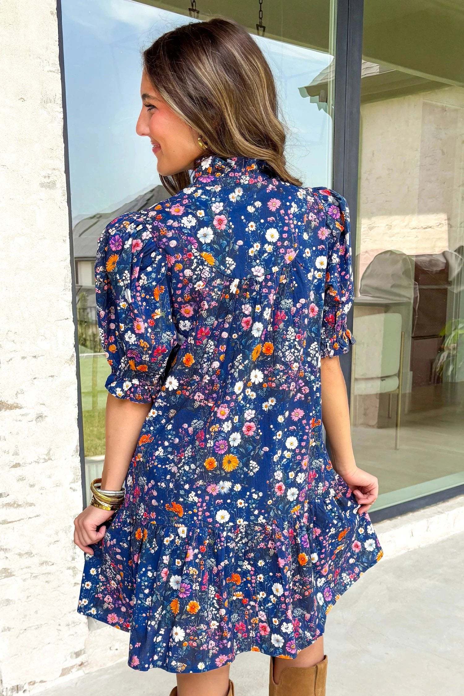 Navy mini dress with wild daisy floral print, split-neck, and puff sleeves