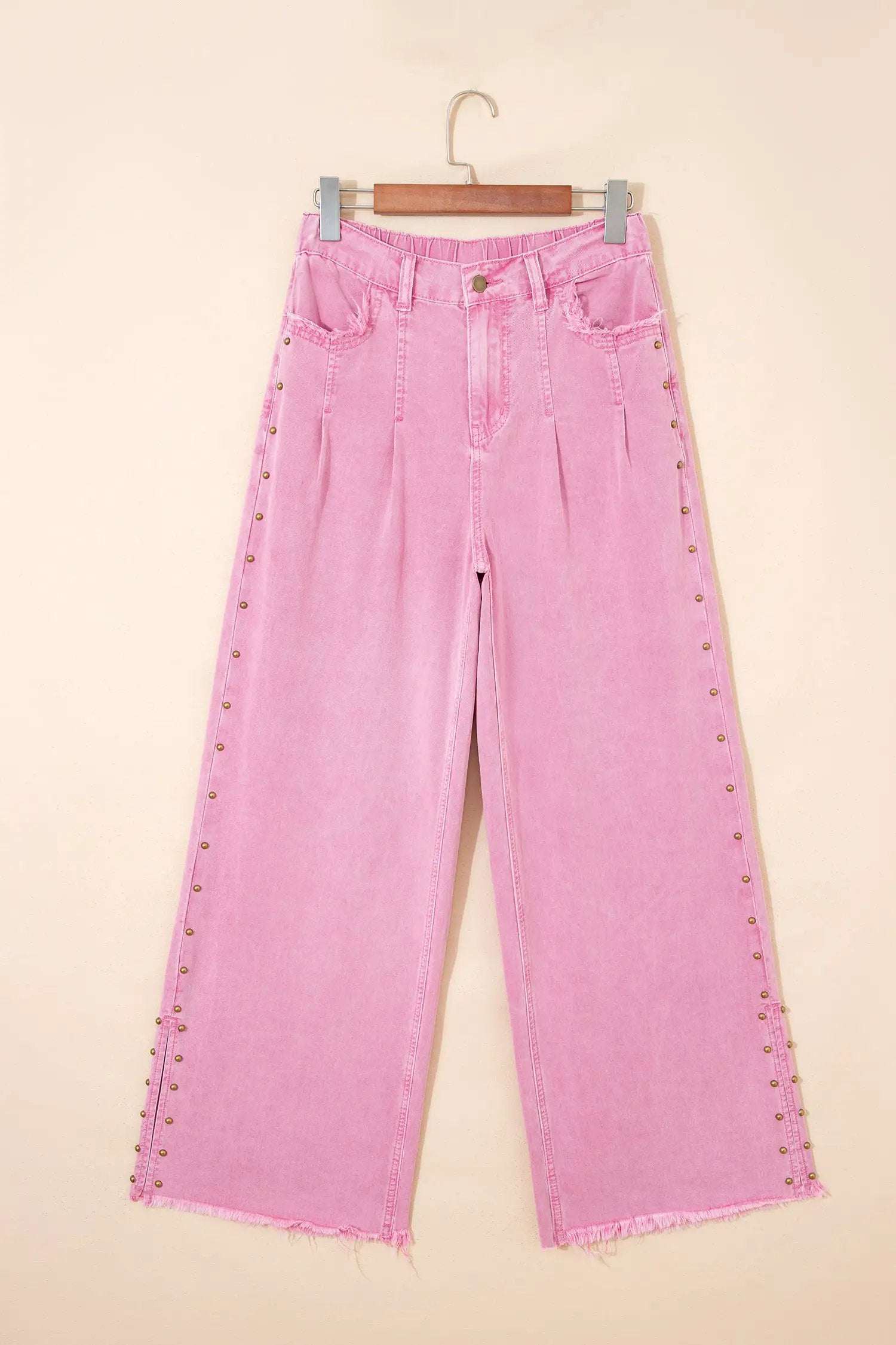Pink high-rise wide-leg jeans with beaded side detail and split hem on a model