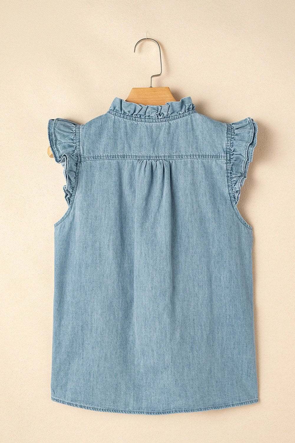 Woman wearing a frill trim V-neck chambray tank top exuding chic mom energy