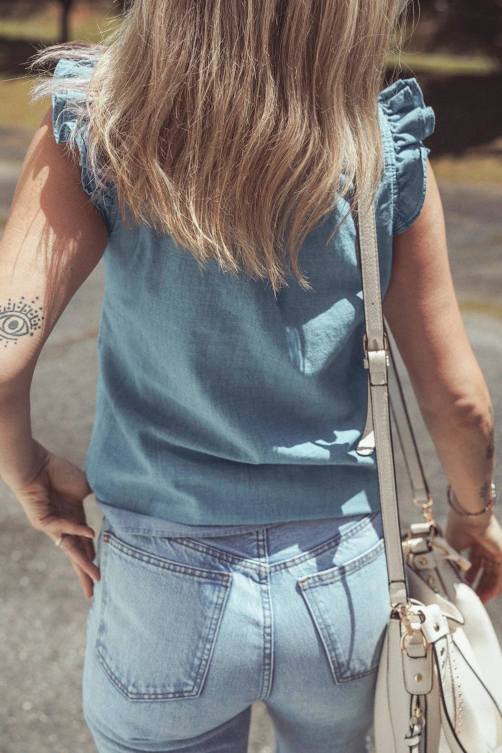Woman wearing chic mom energy frill trim chambray V-neck tank top