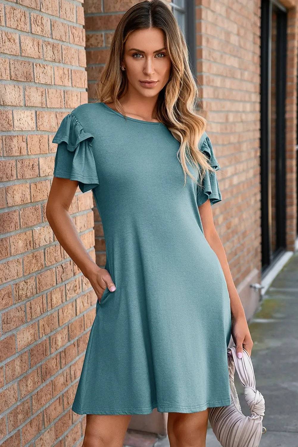 Woman wearing round neck double-ruffle short sleeve mini dress in casual setting