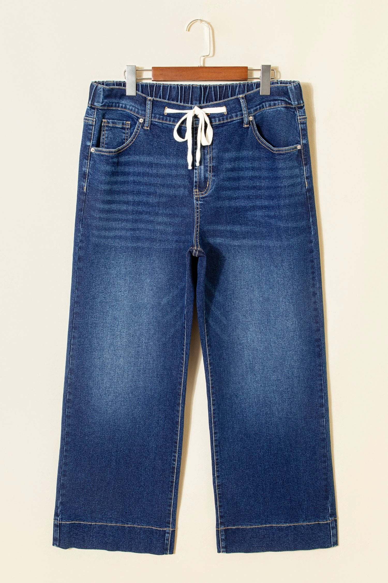 Plus size acid wash high rise wide leg jeans with lace-up waistband showcasing Main Character Energy style