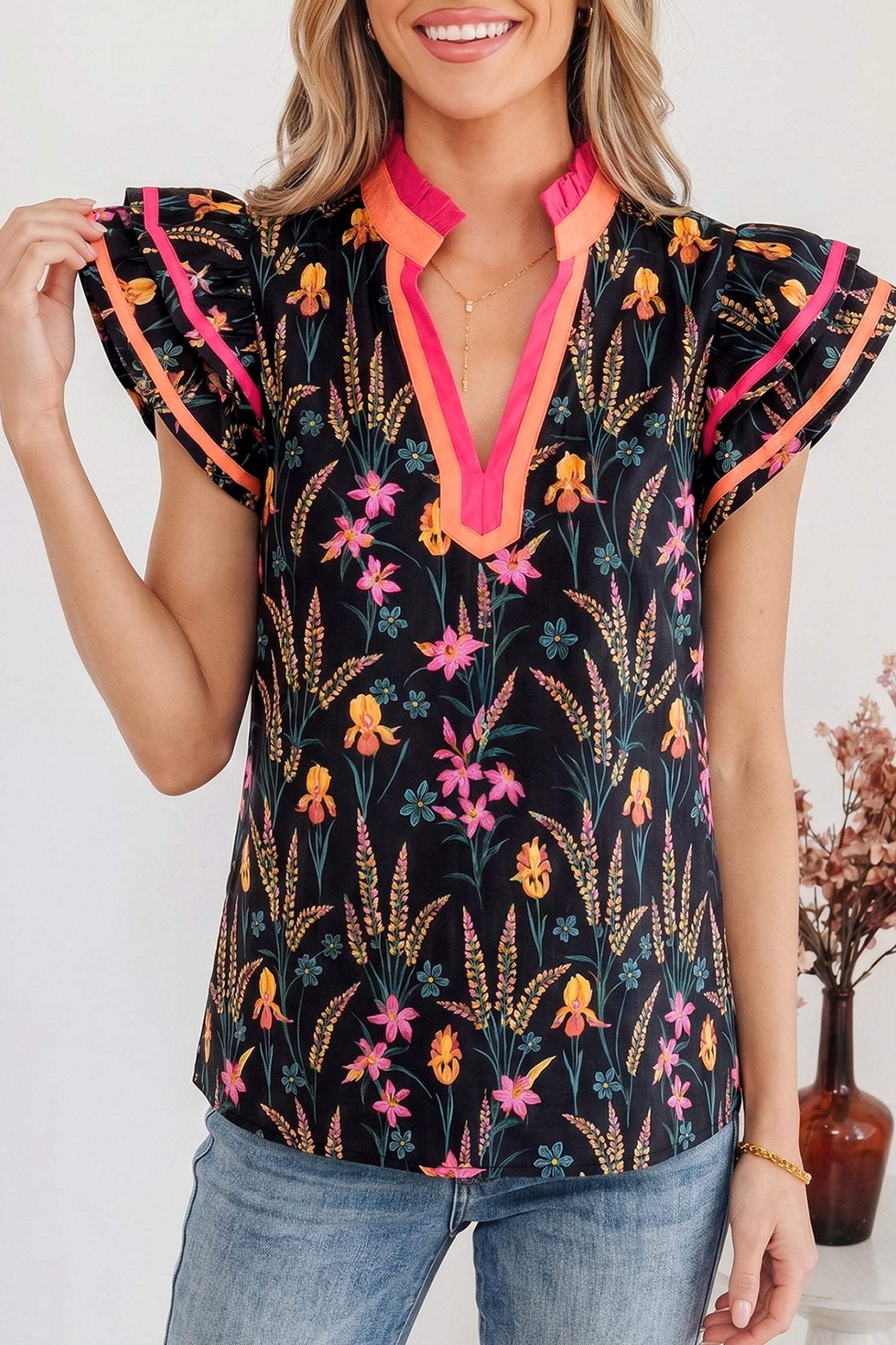 Black floral print tiered blouse with flutter sleeves and contrast trim neckline
