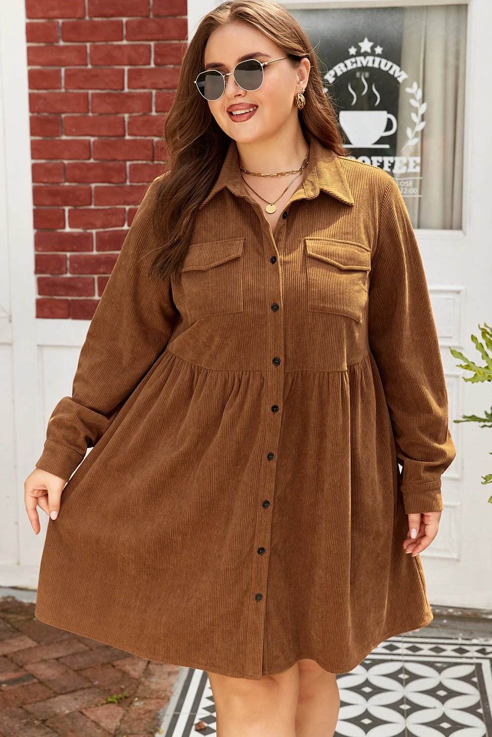 Plus size brown corduroy button-front shirt dress with collared neckline and A-line silhouette