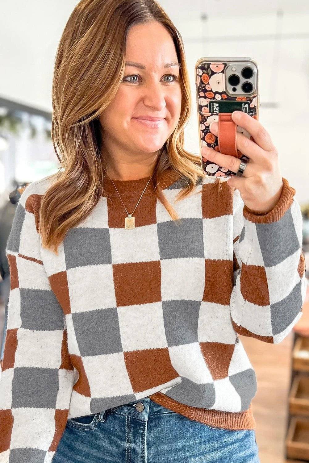 Plus size checkered crewneck sweater in brown, white, and gray with ribbed cuffs and hem for cozy layering