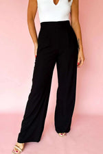 Black pleated pull-on wide-leg pants with elastic waist embodying Boss Mom Energy style