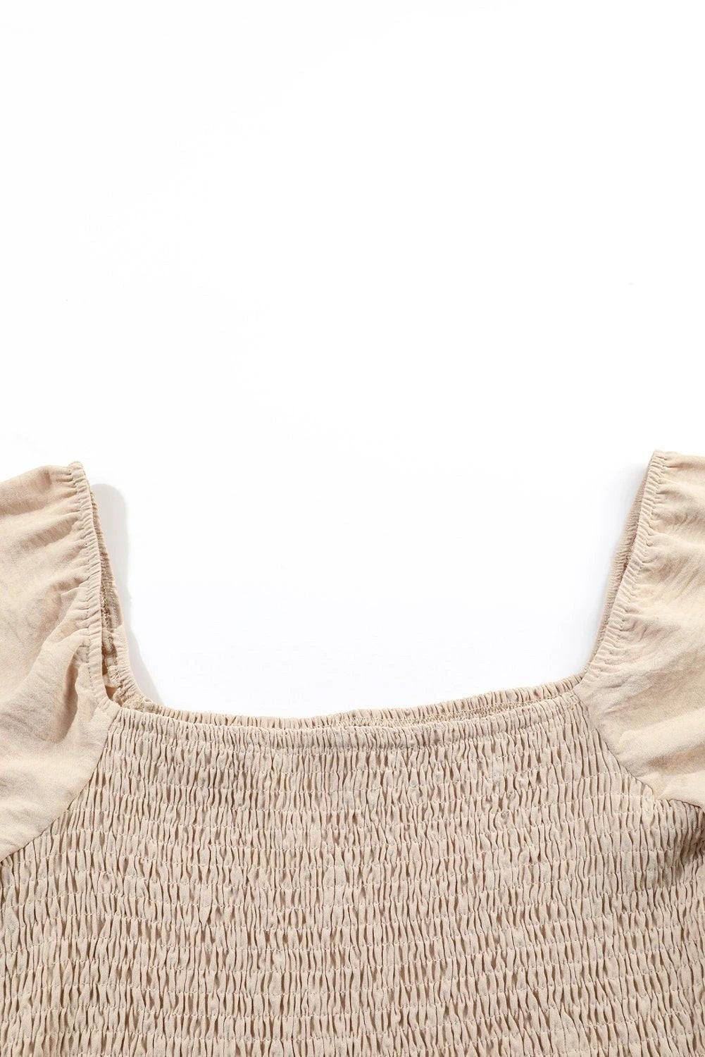 Woman wearing a bubble sleeve smocked square-neck wide-leg jumpsuit in soft breathable fabric
