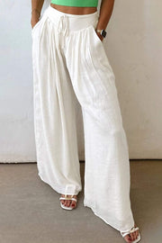 White drop-waist pleated wide-leg cotton-linen pants with adjustable waistband and side pockets