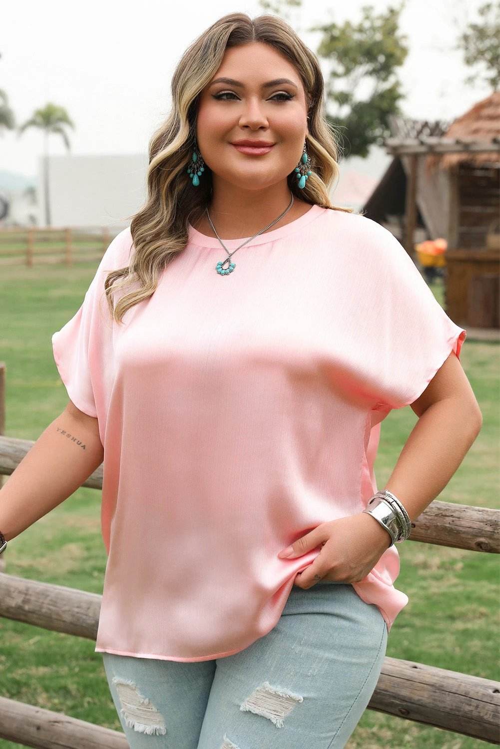 Plus size soft pink metallic gloss satin top with batwing sleeves and relaxed fit showcasing effortless shine