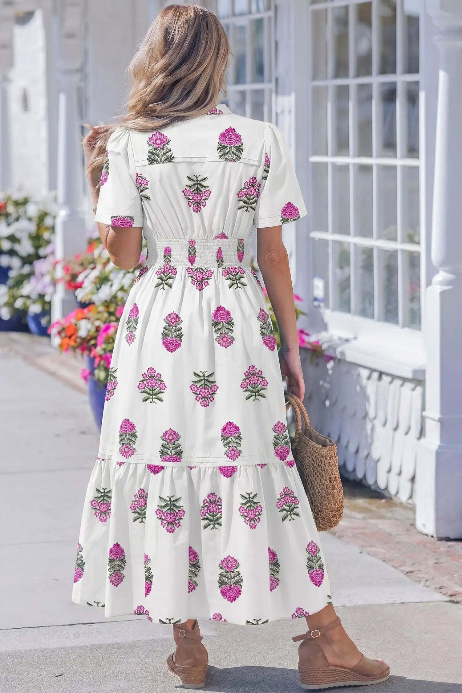 Woman wearing a floral print split neck maxi dress with shirred waist and ruffle hem embodying main character energy