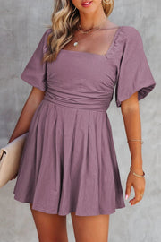Woman wearing Valerian square-neck ruched romper with puff sleeves on vacation