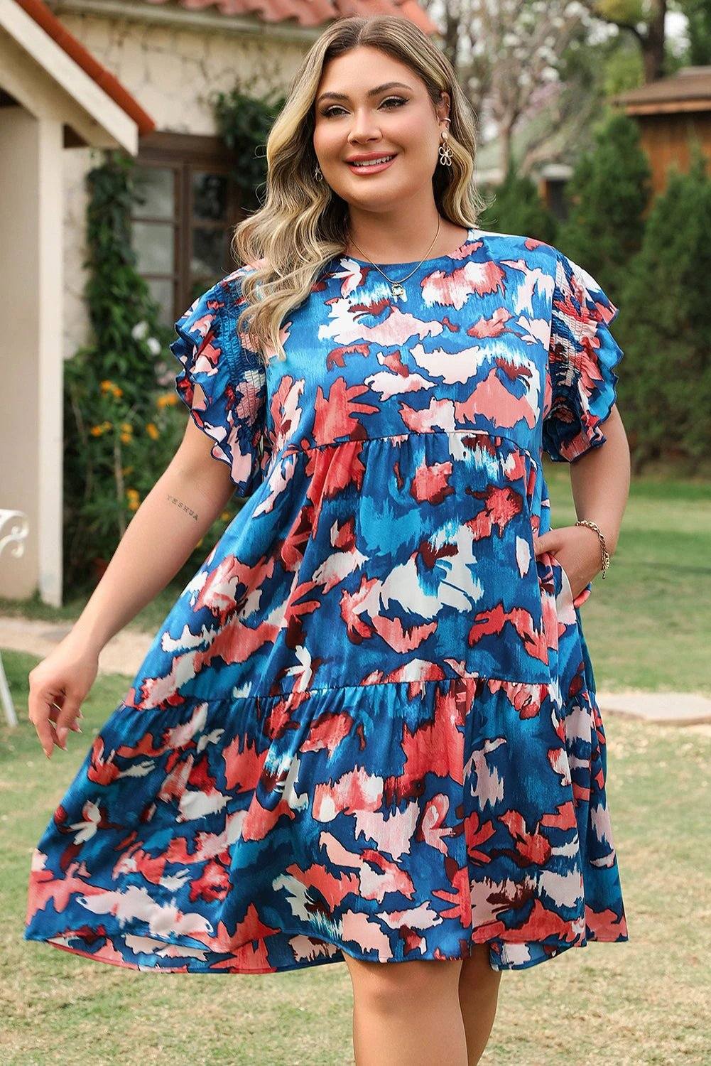 Plus size abstract print shirred ruffled short sleeve tiered mini dress on plus size model