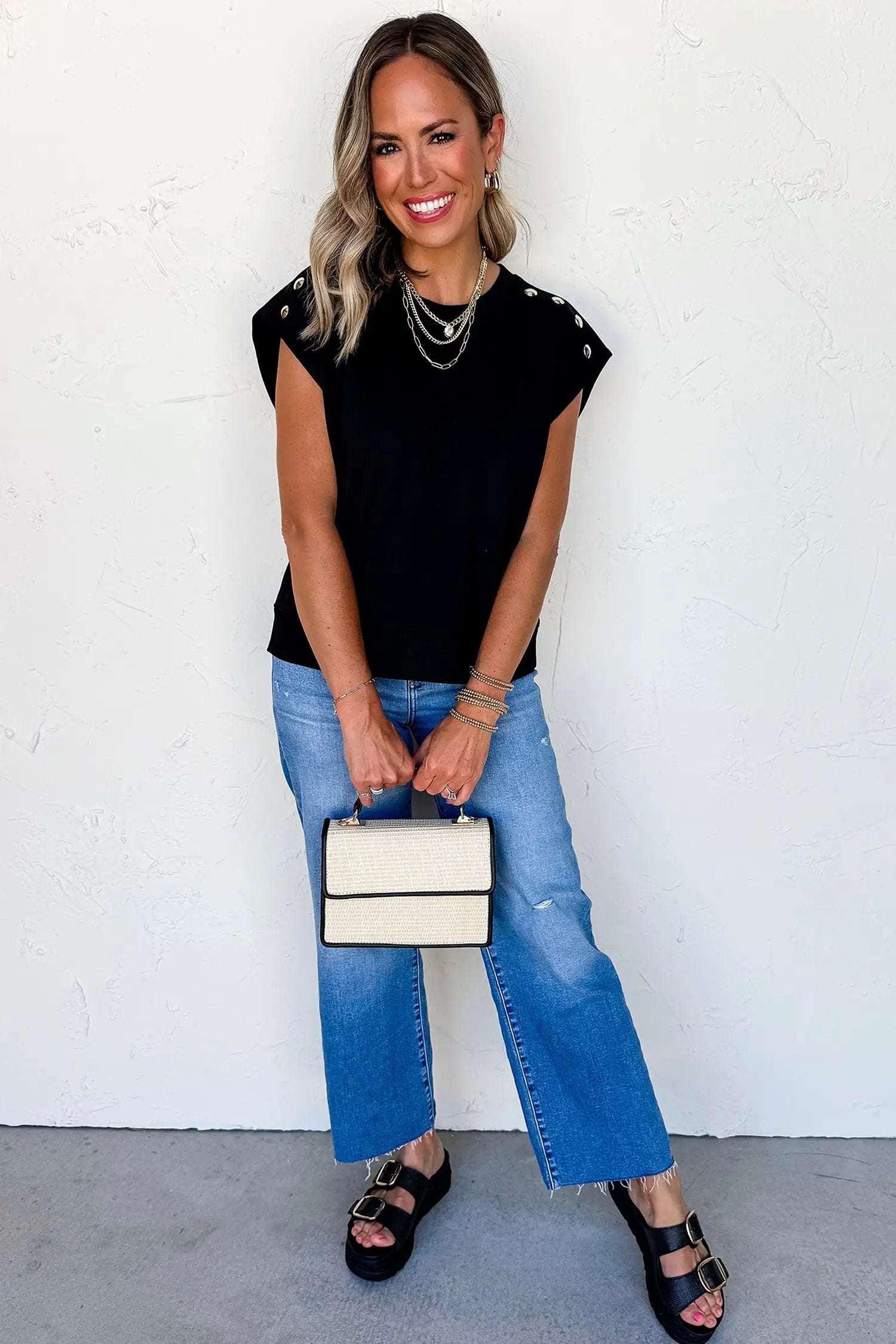 Black short sleeve top with metal button details for effortless chic mom style