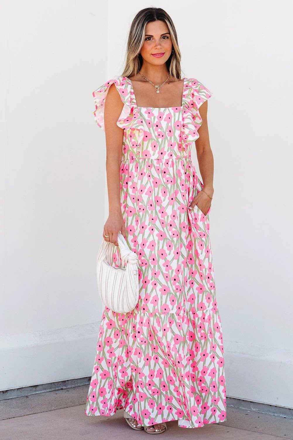 Woman wearing pink floral print boho maxi dress with square neck and ruffled straps