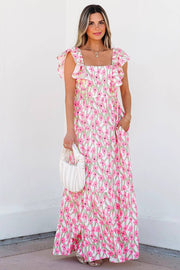 Woman wearing pink floral print boho maxi dress with square neck and ruffled straps