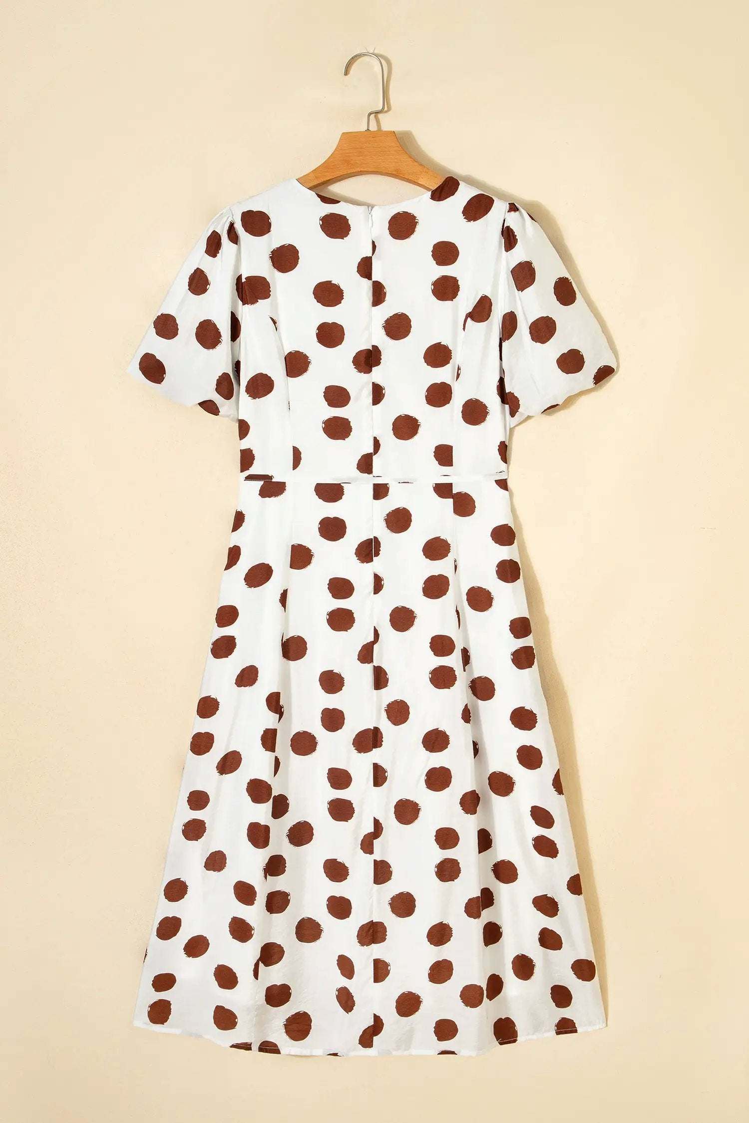 Woman wearing Polka Dot Daydream white midi dress with brown polka dots and tie waist.