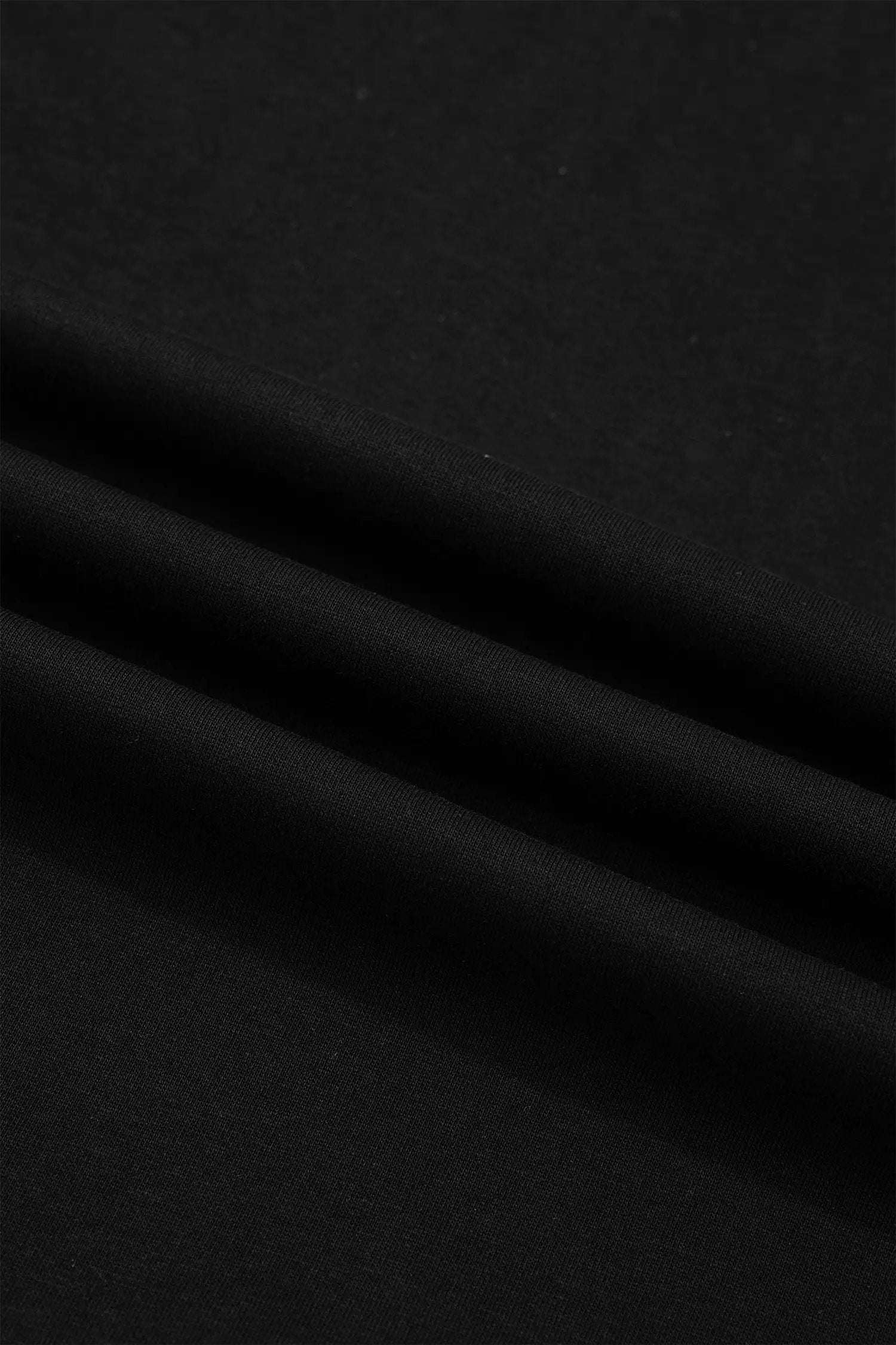 Black short sleeve top with metal button details for effortless chic mom style