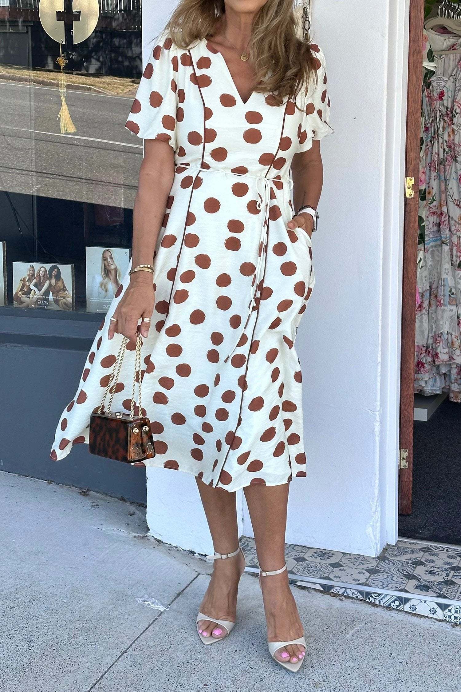 White midi dress with brown polka dots, V-neck, short sleeves, and tie waist Polka Dot Daydream