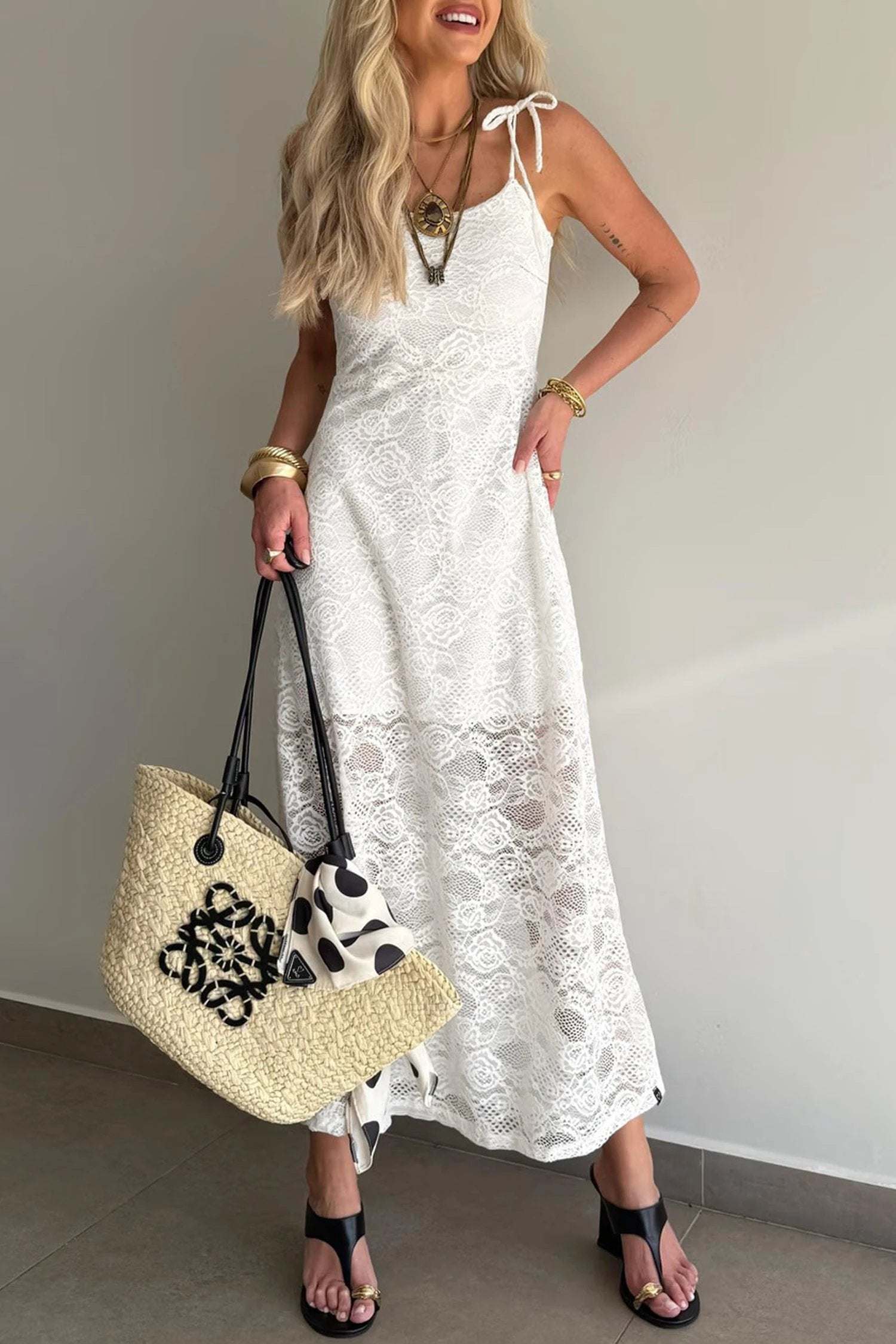 Woman wearing floral lace overlay maxi dress with spaghetti straps outdoors