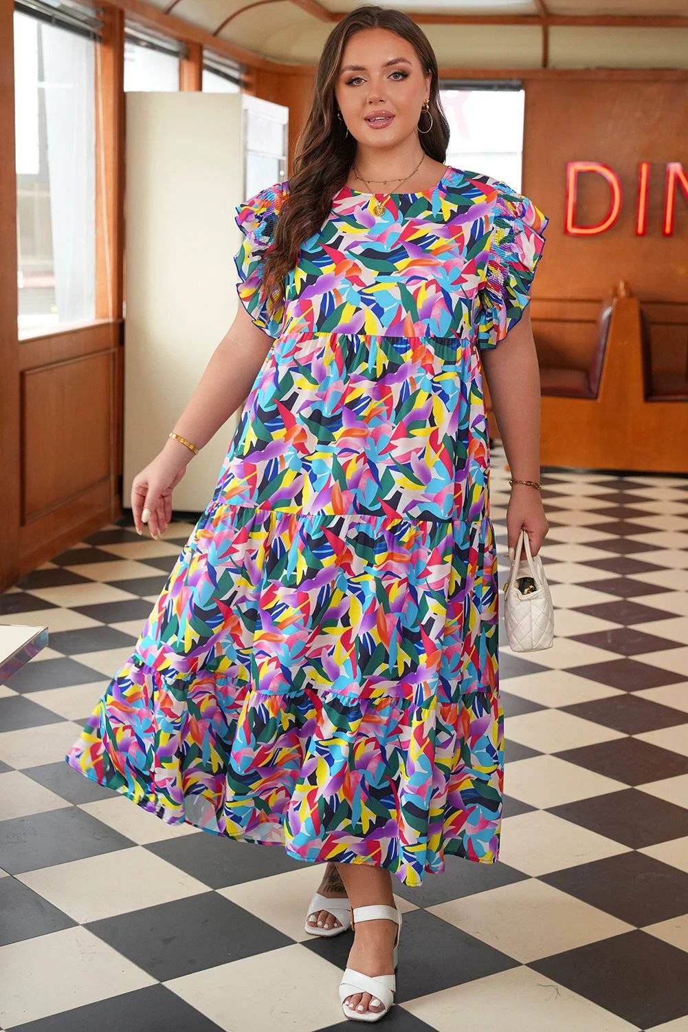 Plus size Main Character Energy maxi dress with geometric print, ruffled short sleeves, and tiered A-line silhouette