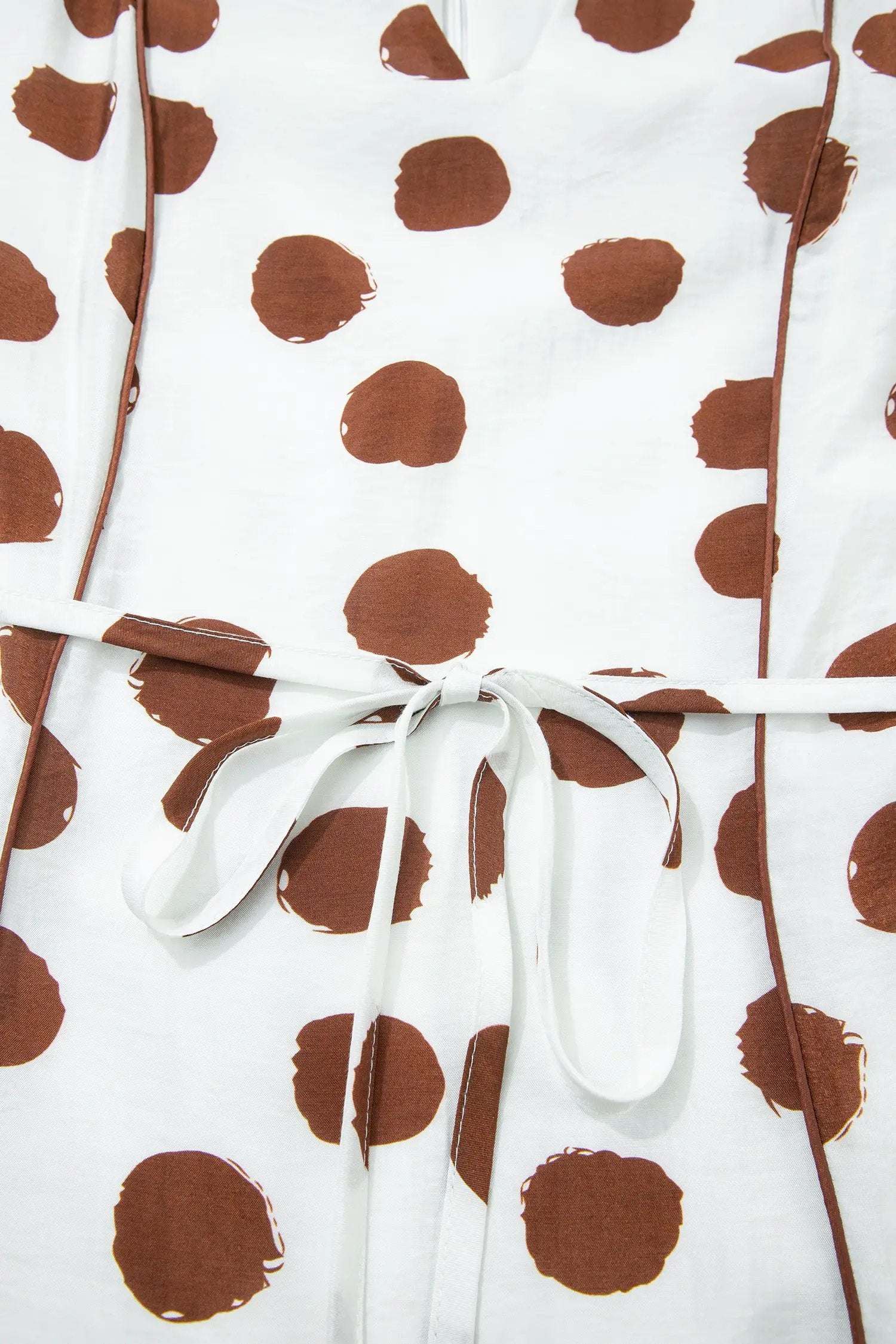 White midi dress with warm brown polka dots, V-neck, short sleeves, and tie waist Polka Dot Daydream style