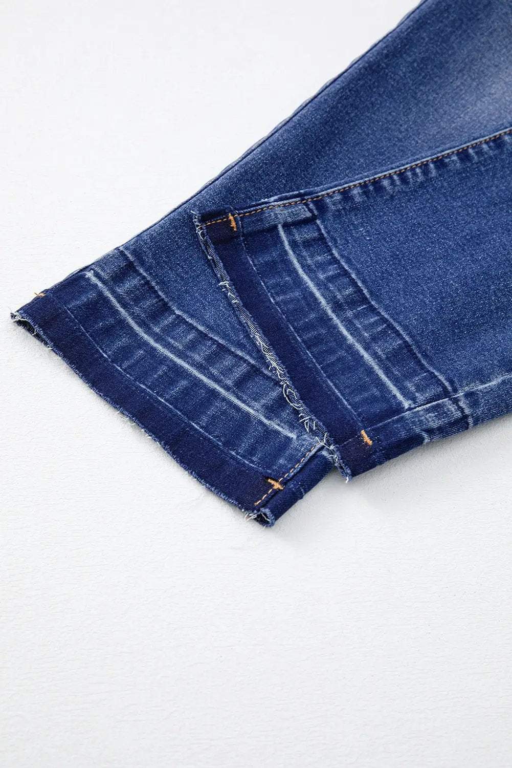 Woman wearing whiskered wash cropped jeans with raw hem showcasing main character energy style