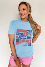 Light blue women's tee with "She Loves Jesus And America Too" patriotic flag graphic