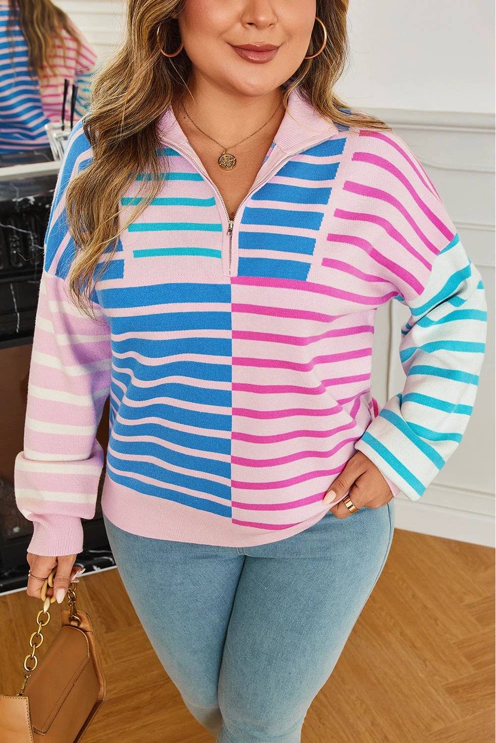 Plus size striped colorblock half zip sweater with pastel pink, blue, and white stripes on a relaxed fit model