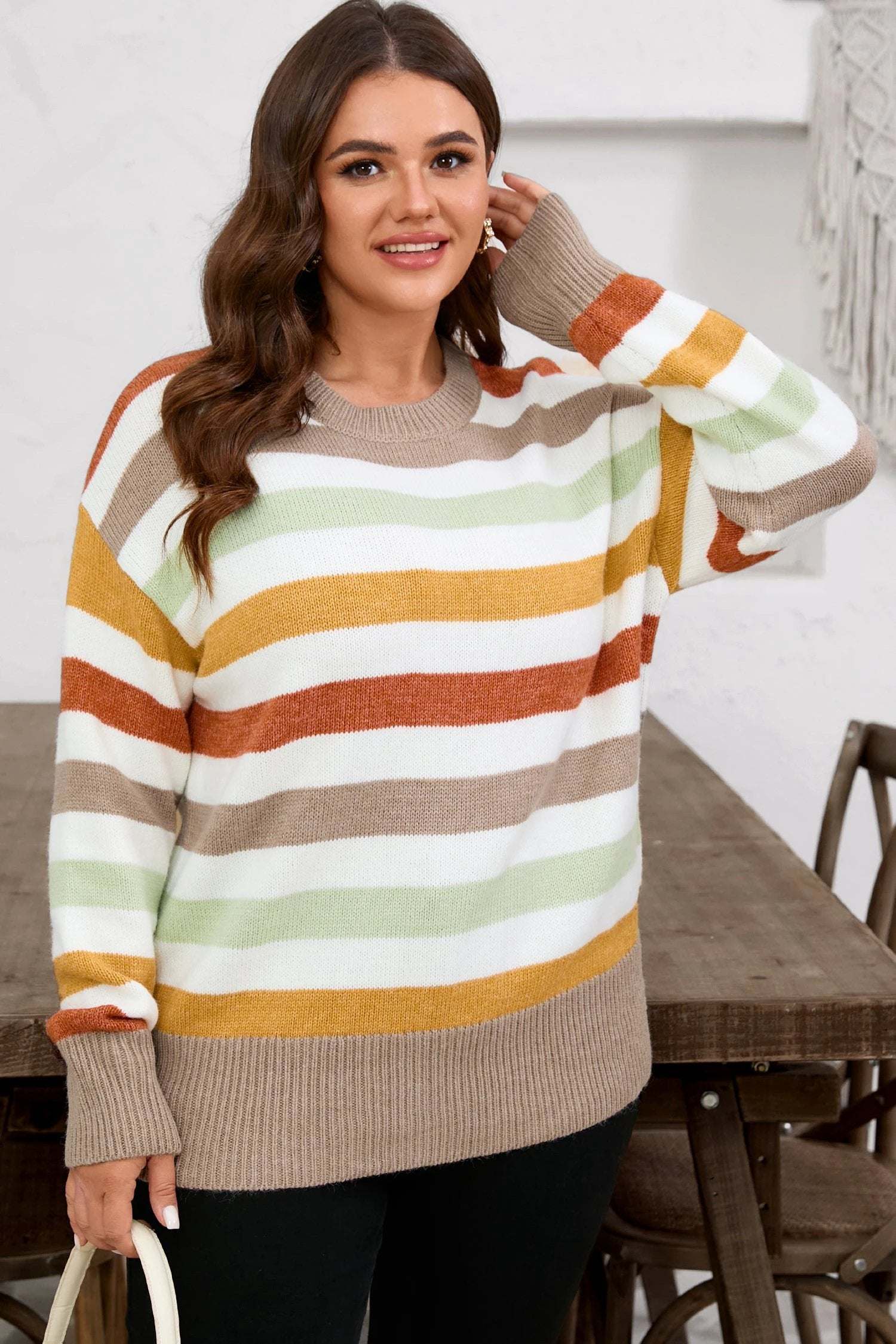 Plus size striped colorblock drop shoulder sweater in earthy tones on relaxed model