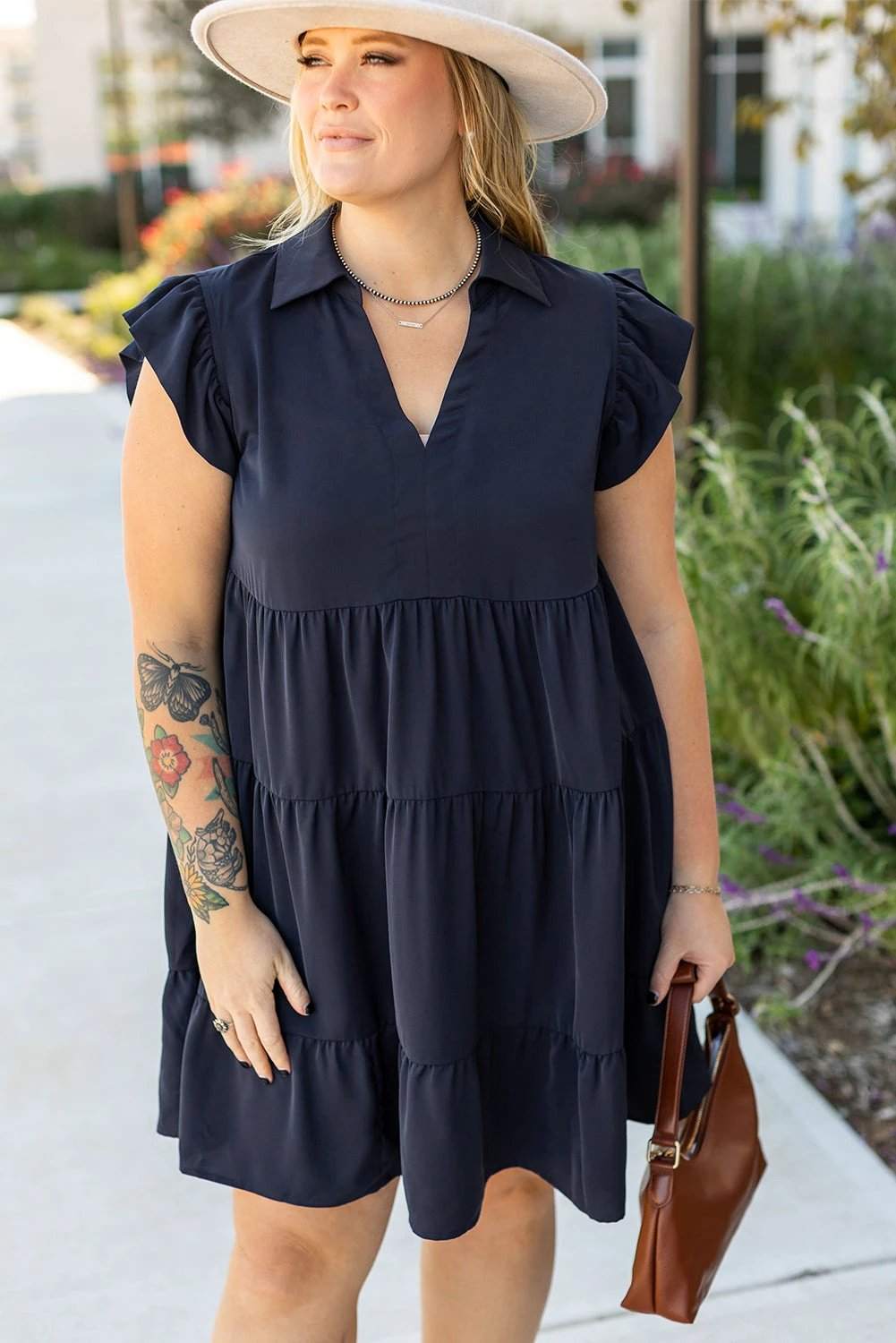 Plus size navy collared V-neck dress with flutter sleeves and tiered skirt