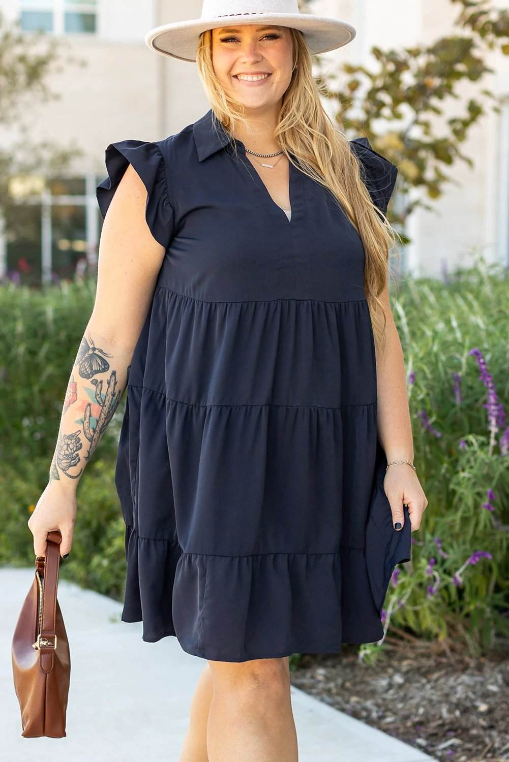 Plus size navy collared V-neck dress with flutter sleeves and tiered skirt